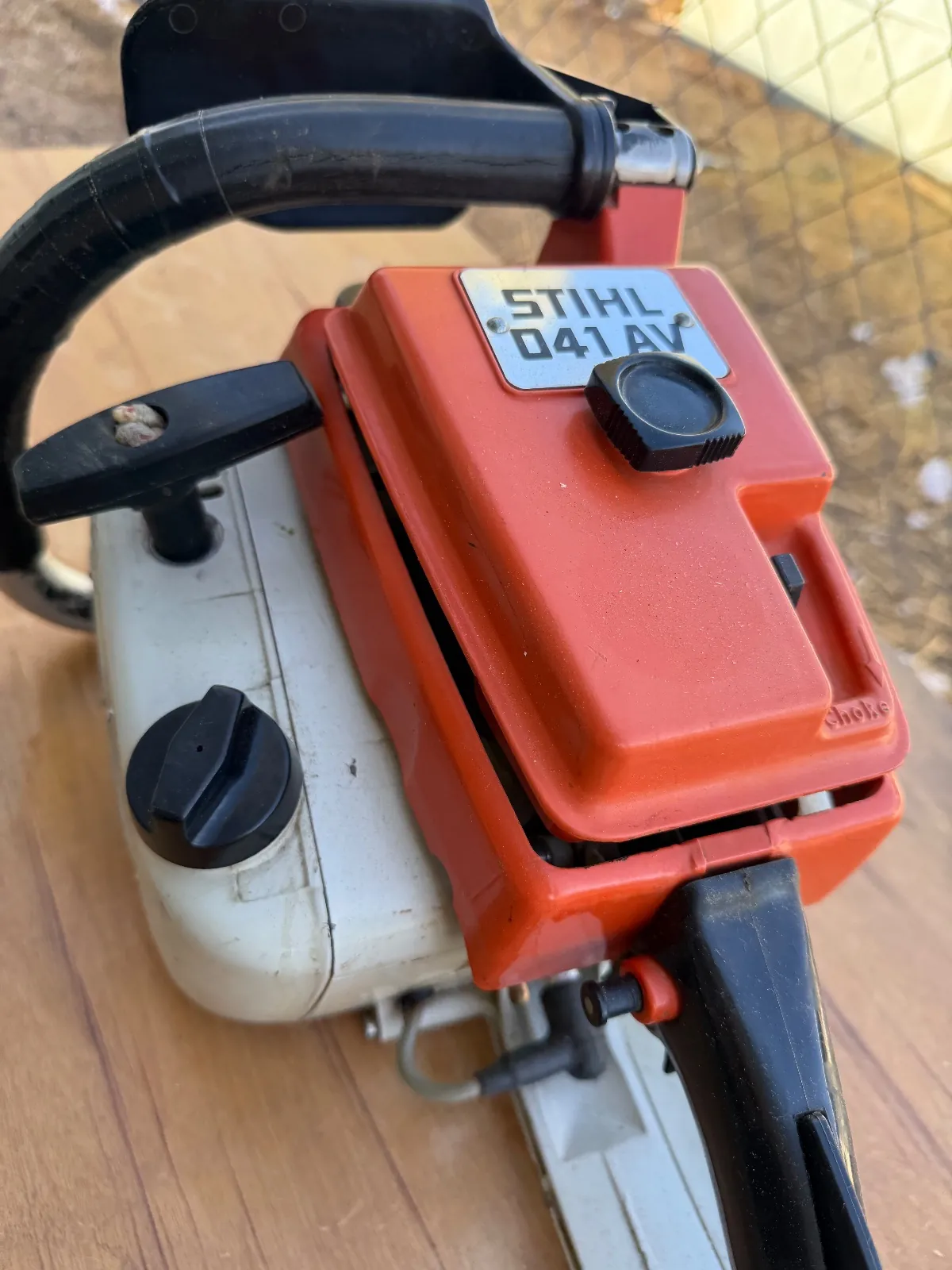 Close-up of the model label on a vintage Stihl 041 AV chainsaw.
